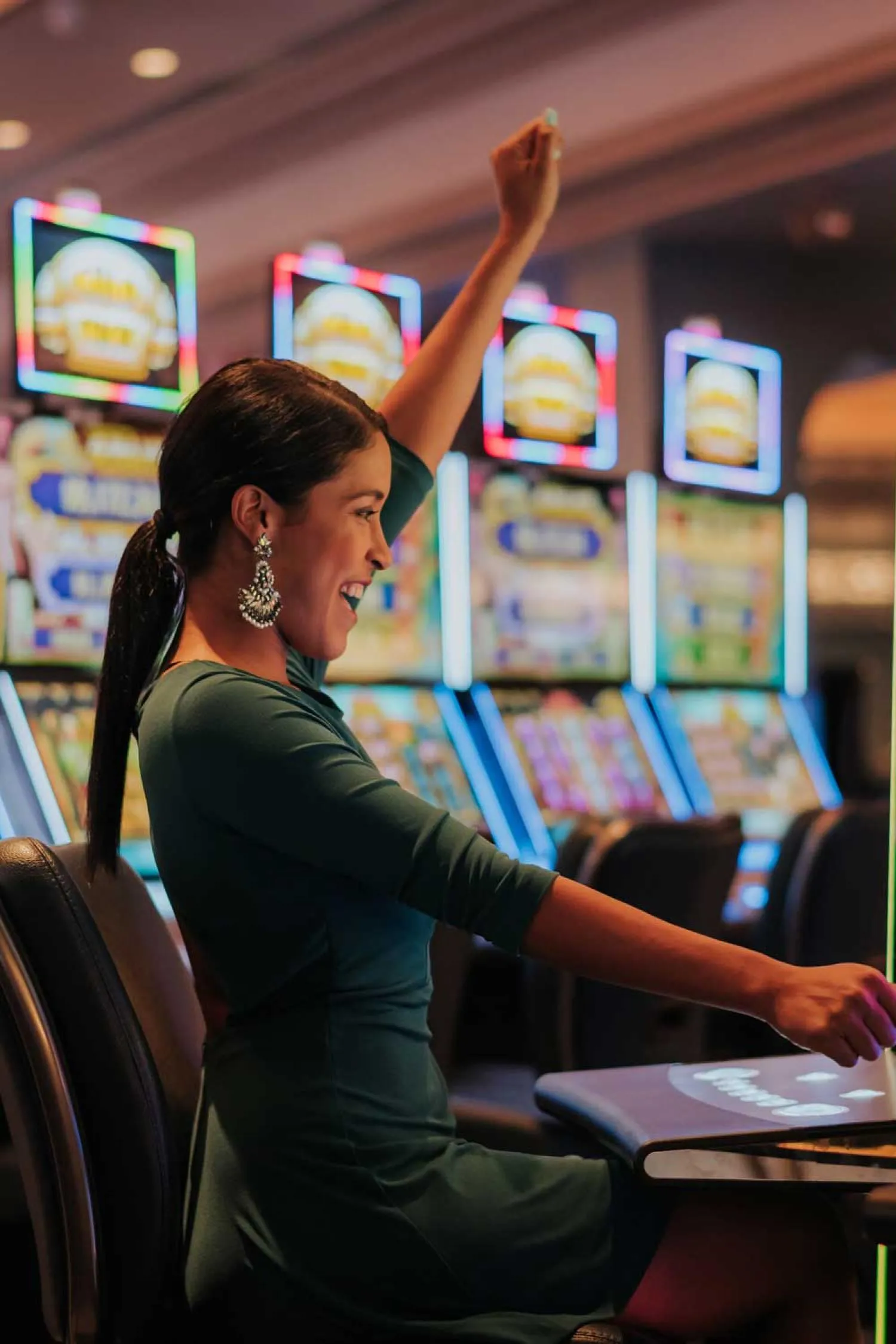 A woman celebrates after winning on a video poker machine.